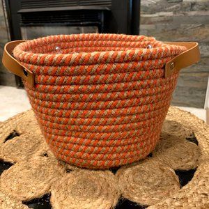 Woven orange and khaki basket with leather handles